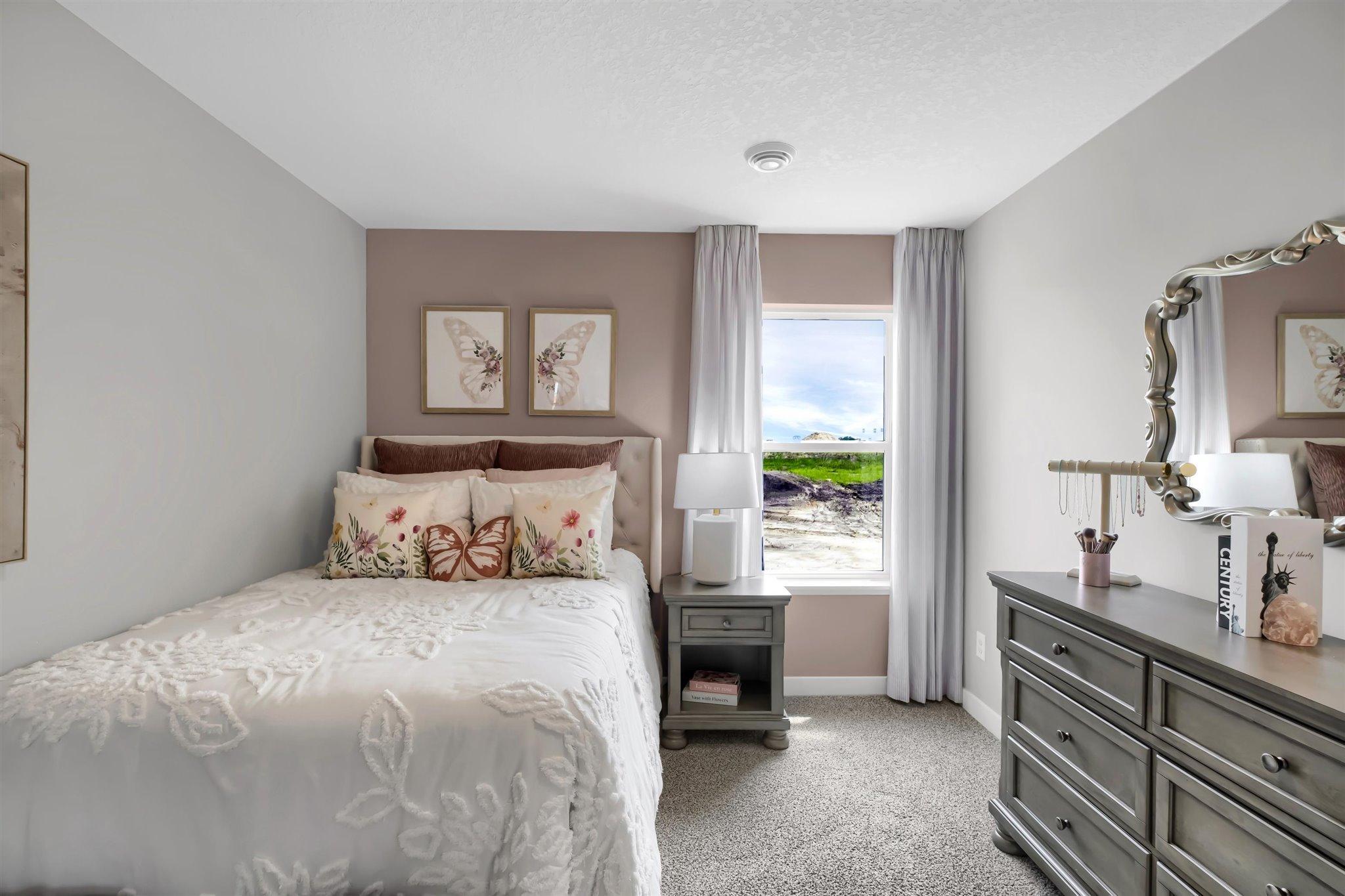 Each of the three bedrooms is unique and offers beautiful views from the large windows. (Model photo, colors may vary)
