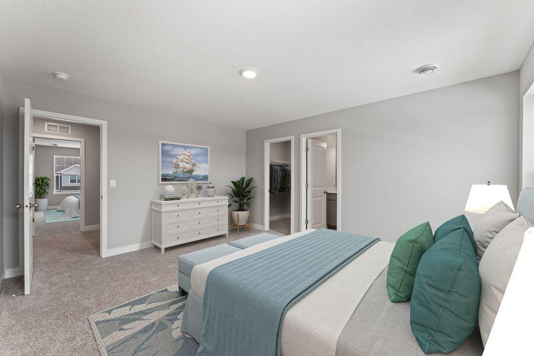 The large primary has enough space for a sitting area as well as a king and a full bedroom set. (Model photo, colors may vary)