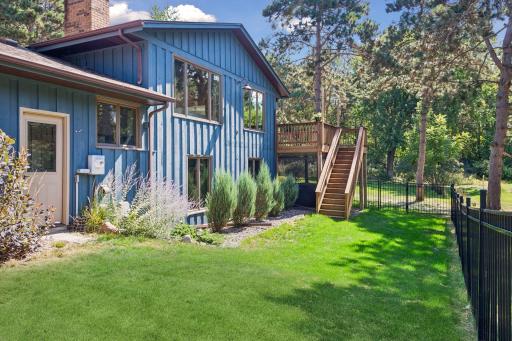 Partially fenced yard with water feature for your listening pleasure from the deck!