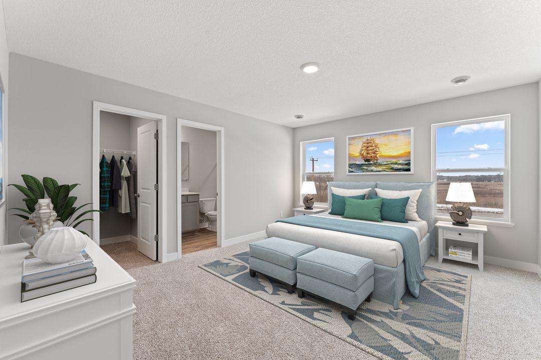 The extra large primary bedroom has a generous walk-in and private en suite. (Model photo, colors may vary)