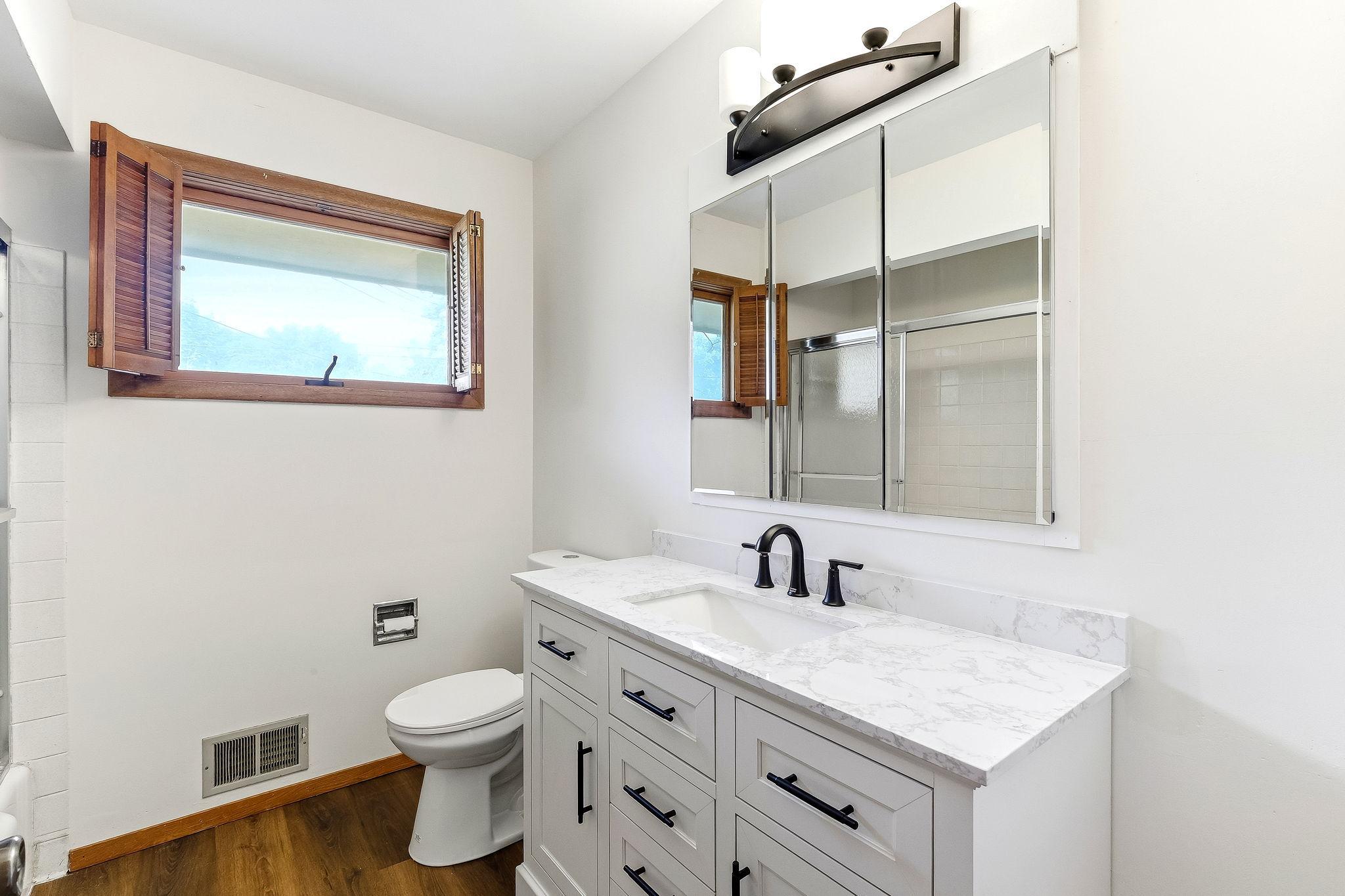 Main floor full bath with new toilet,vanity and lighting.