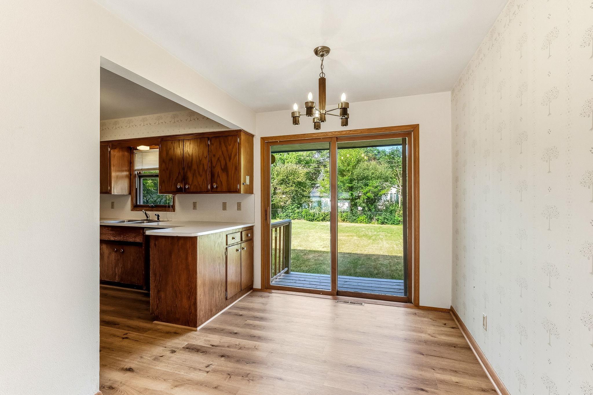 Informal dining room with patio door out to backyard.