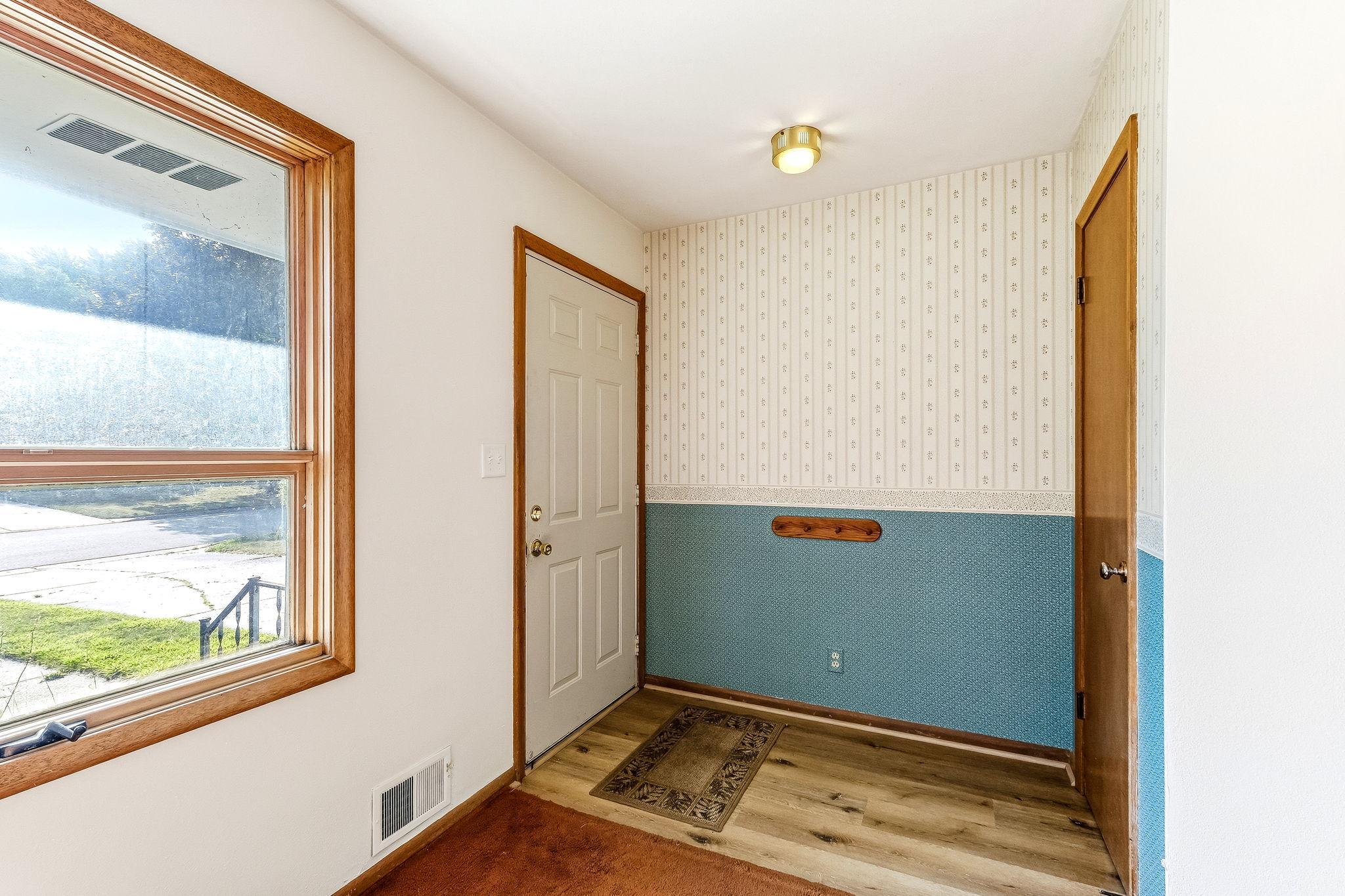 Entry with coat closet and vinyl flooring
