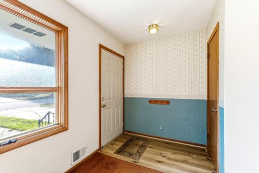 Entry with coat closet and vinyl flooring