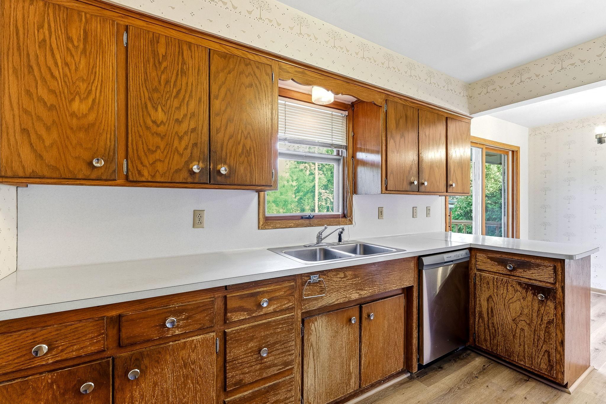 Kitchen window overlooks the large fenced back yard.