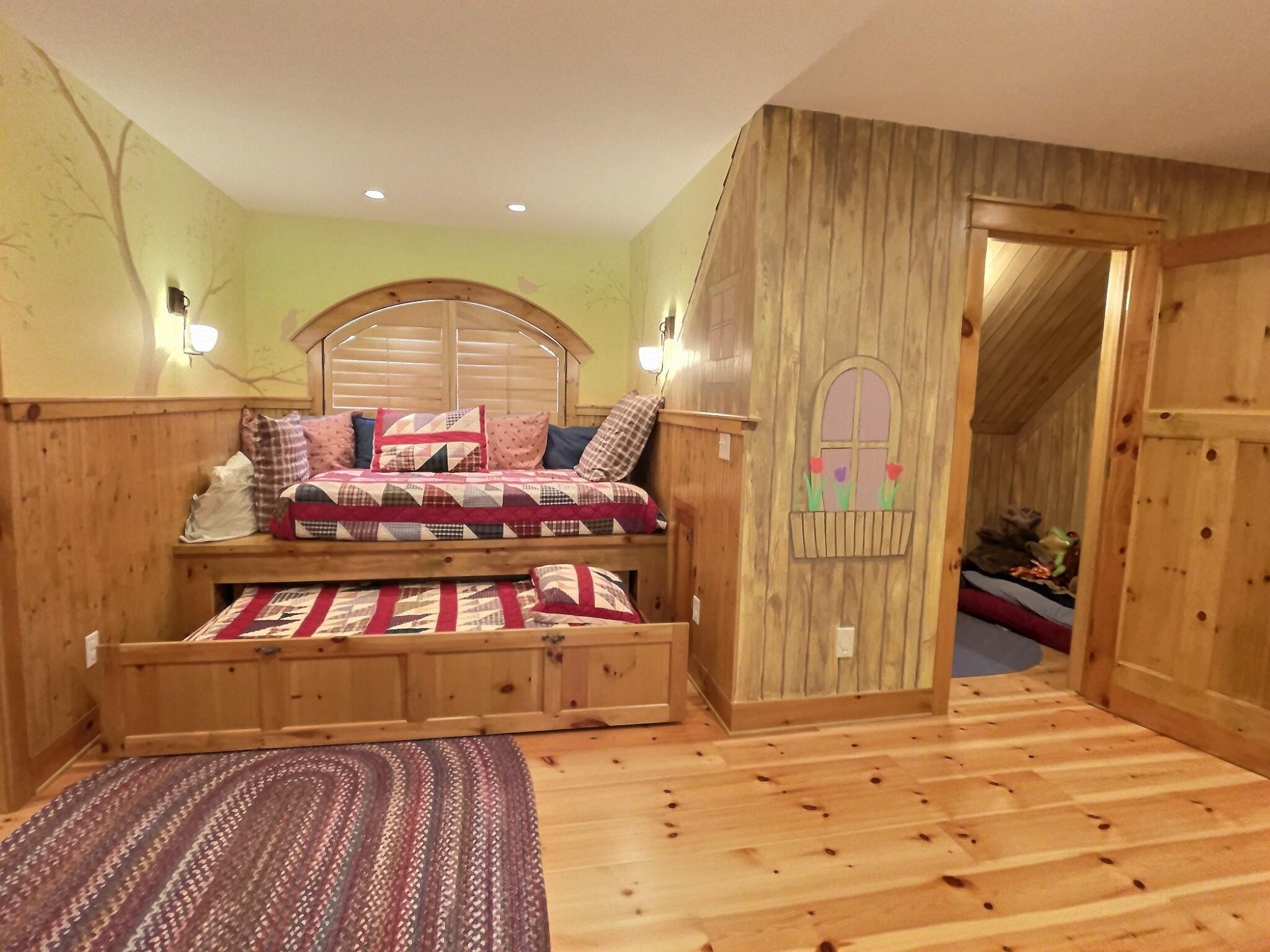 Along side the custom built-in bed is a play room also with hand-painted walls, as spot the kids will love to play.