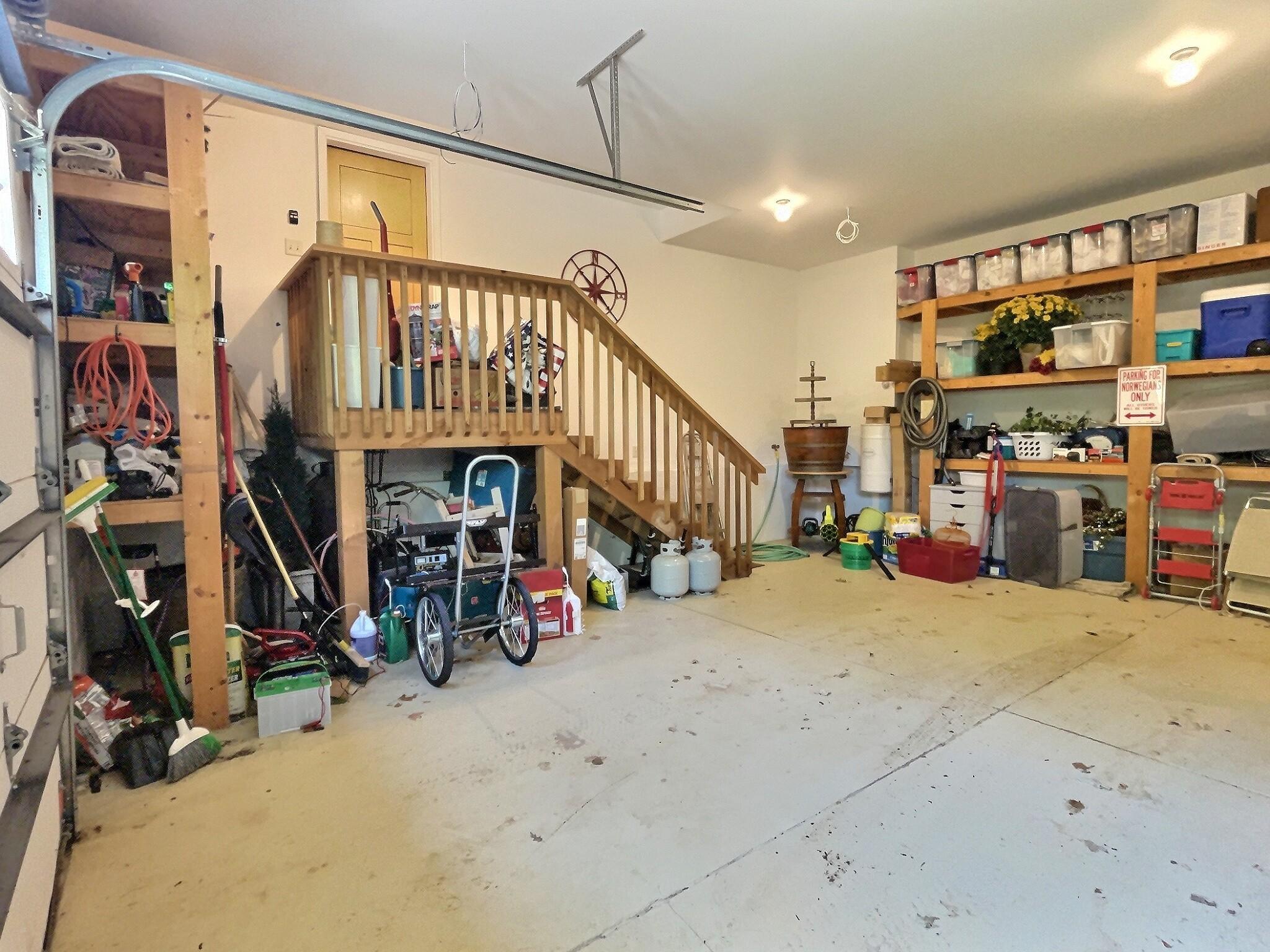 The double garage offers tons of storage space with a staircase that leads to the main level laundry/mud room.