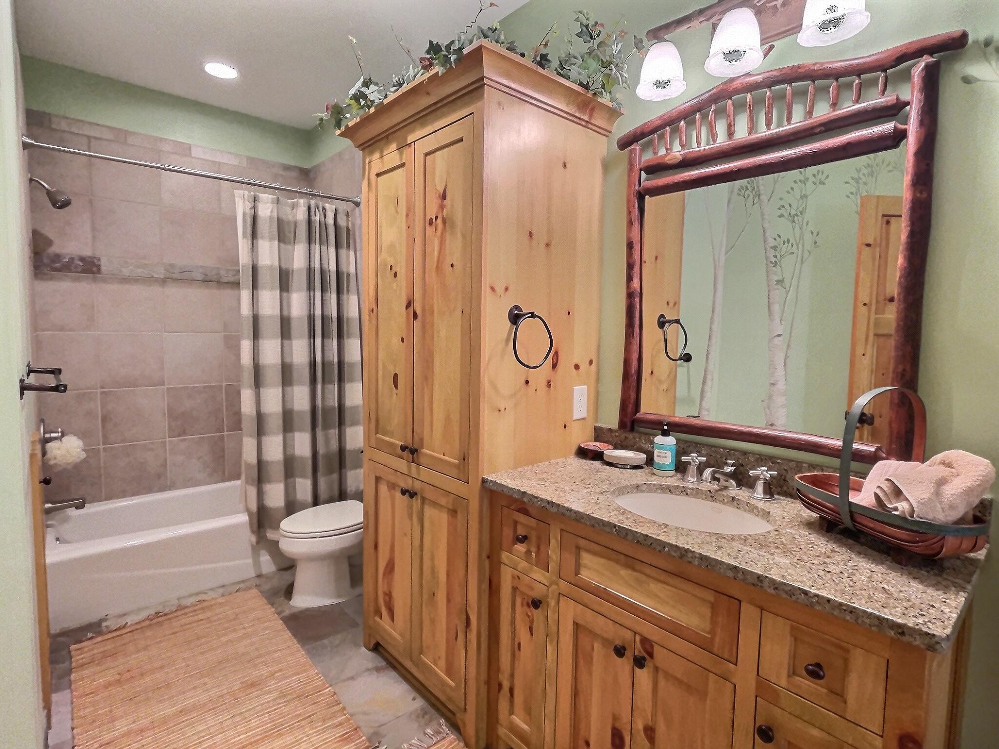 A full private bathroom just off the lower level bedroom offering tons of cabinet & counter space.
