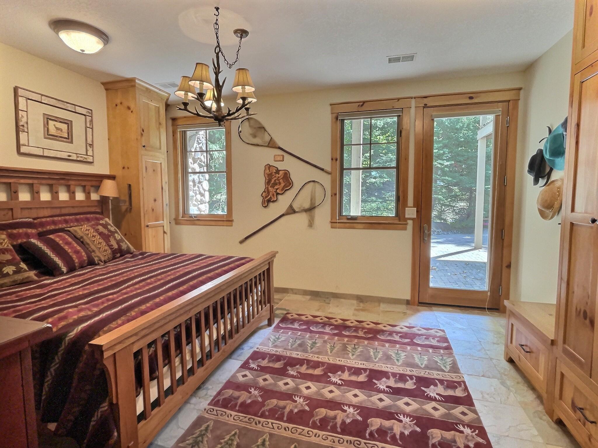 Walk-out to the lakeside patio from the lower level bedroom, ideal for overnight weekend guests.