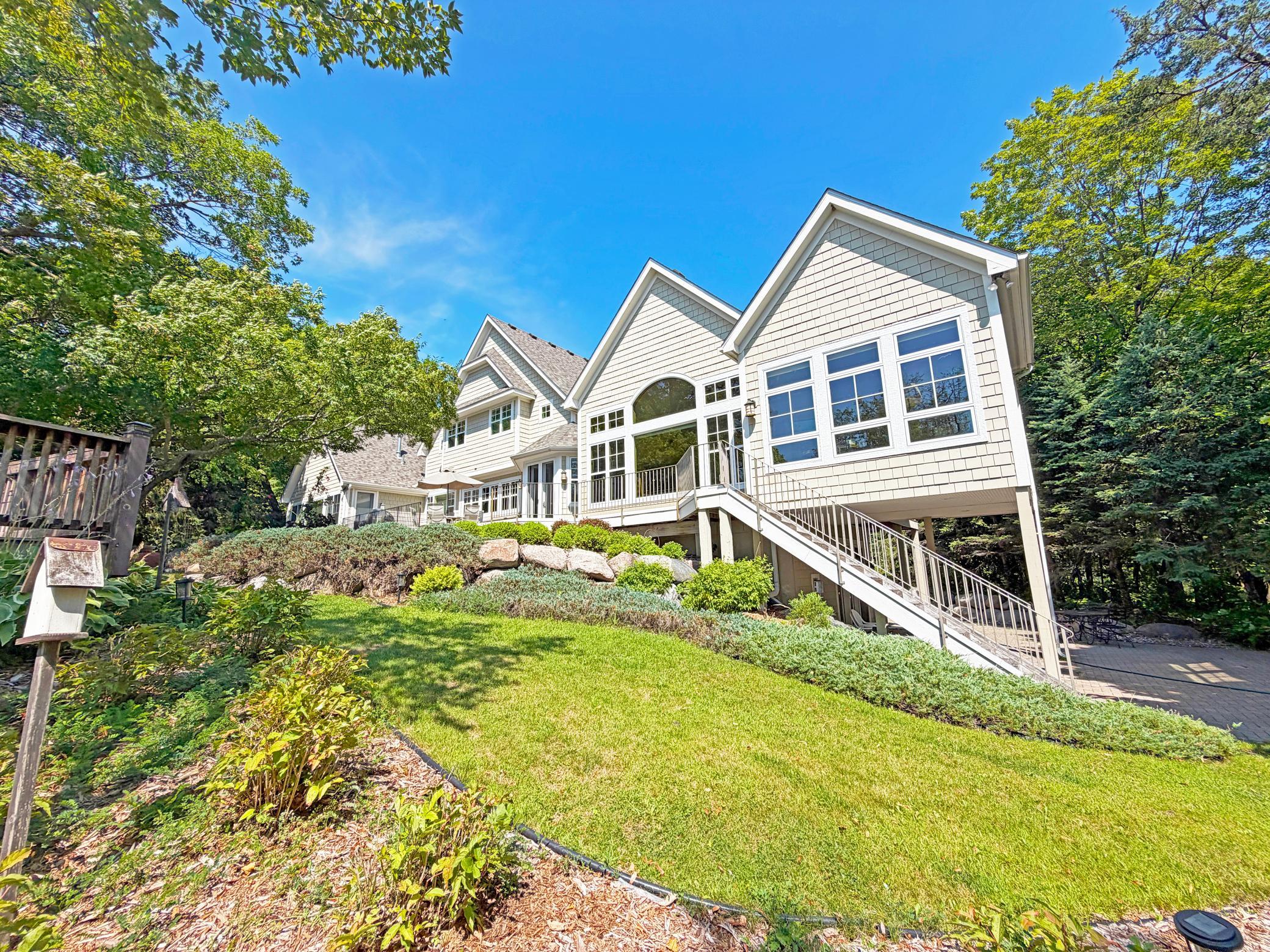 This expansive lake home is tucked in the woods on the pristine waters of Lake Sylvia
