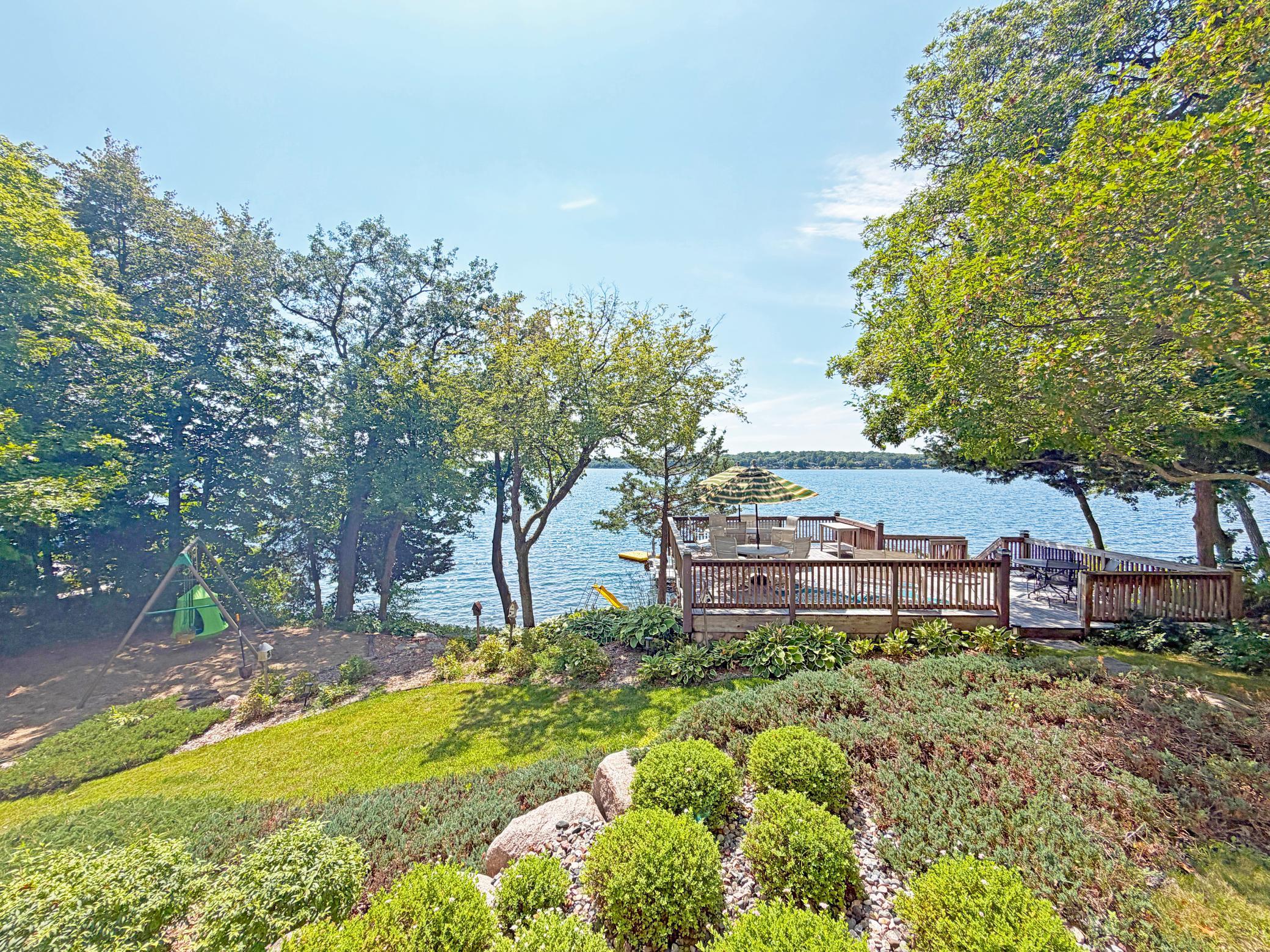 Towering trees and a slope leading to the shoreline offers privacy and seclusion.