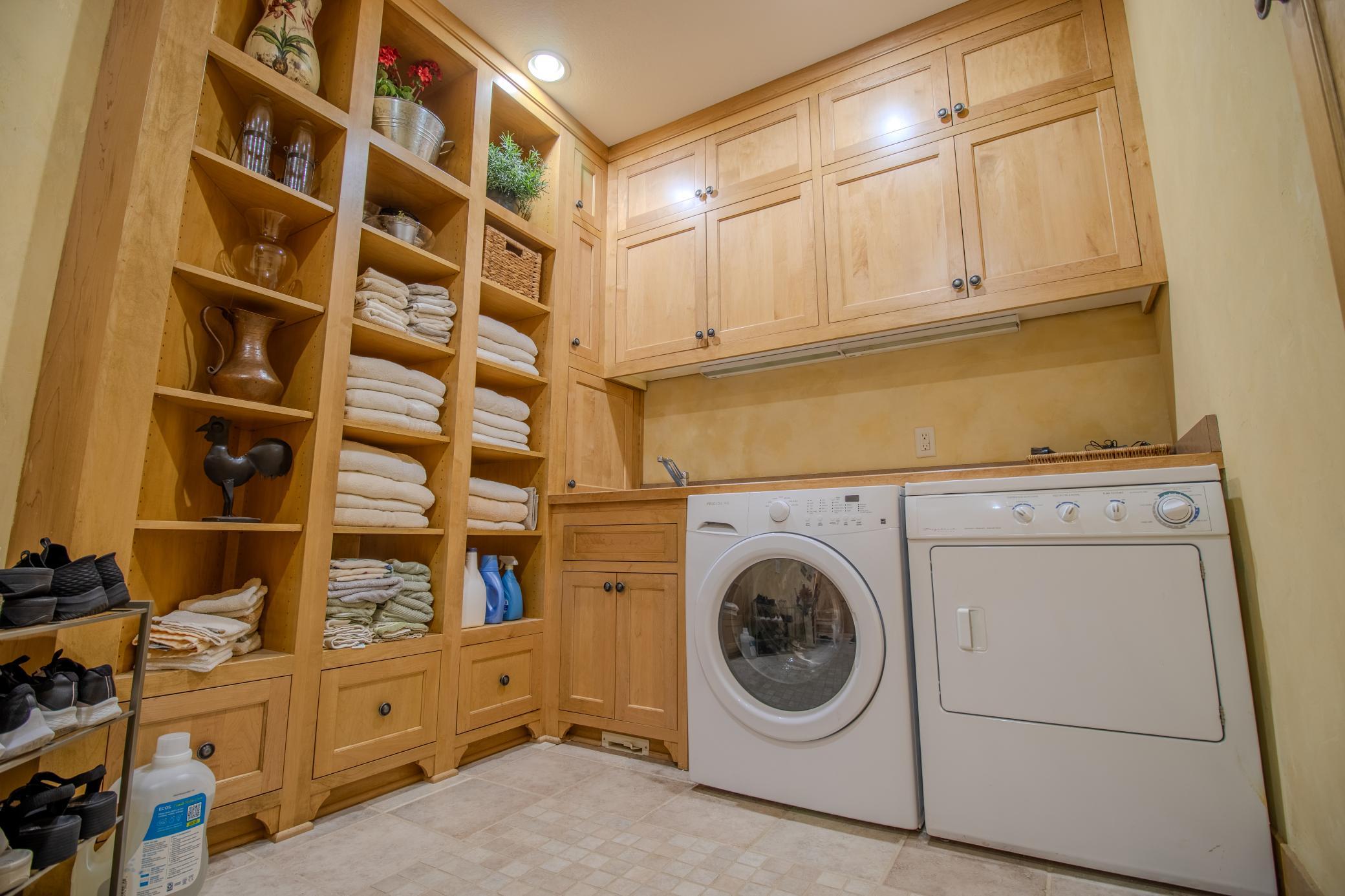 Enjoy an abundance of storage space to keep you organized and counter space for sorting and folding, a dream laundry/mud room!