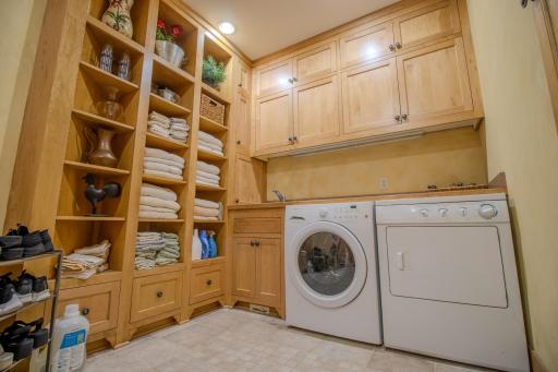 Enjoy an abundance of storage space to keep you organized and counter space for sorting and folding, a dream laundry/mud room!