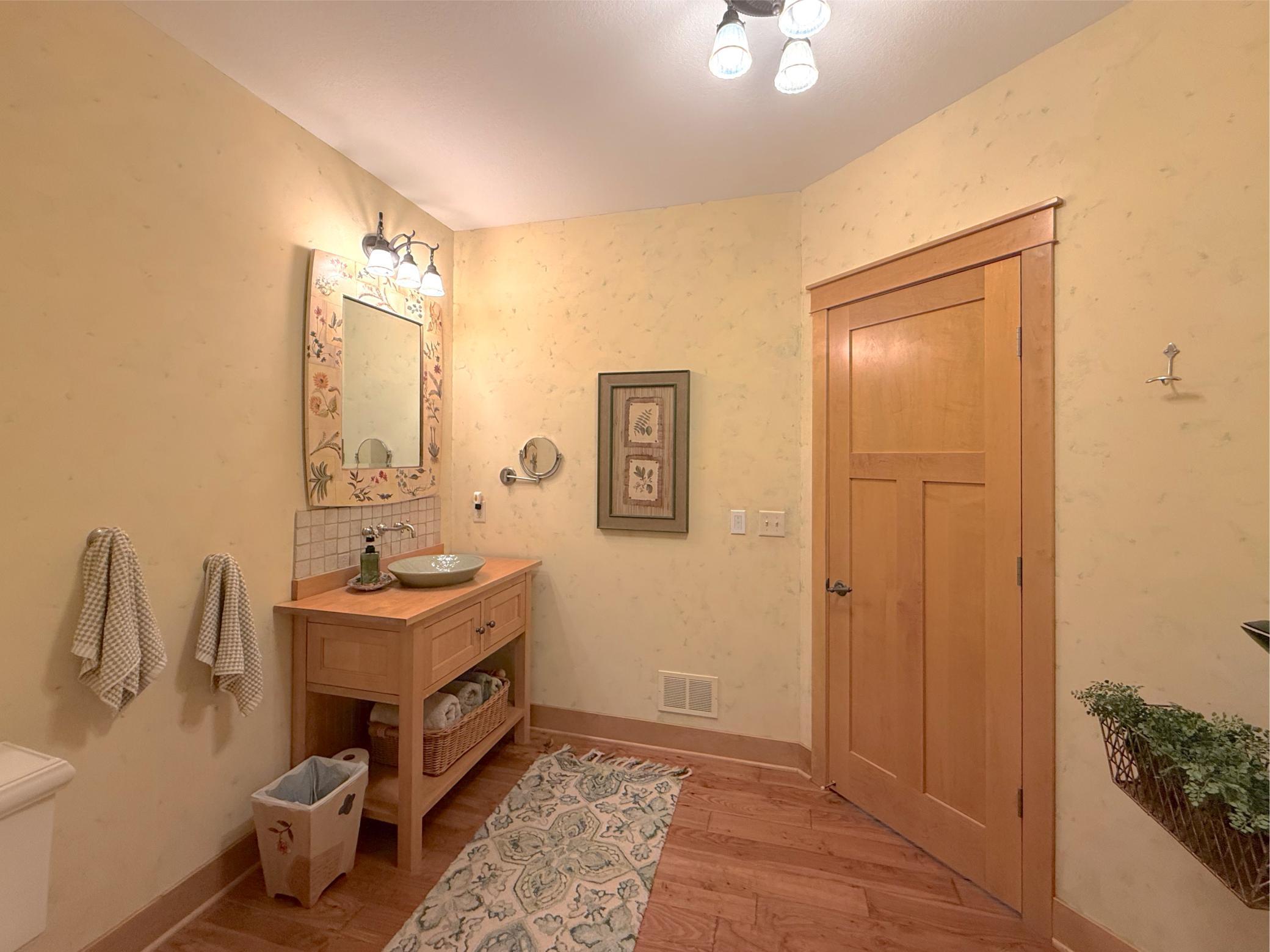The beautiful main level three-quarter bathroom doubles as a walk-through bathroom for the main level bedroom.