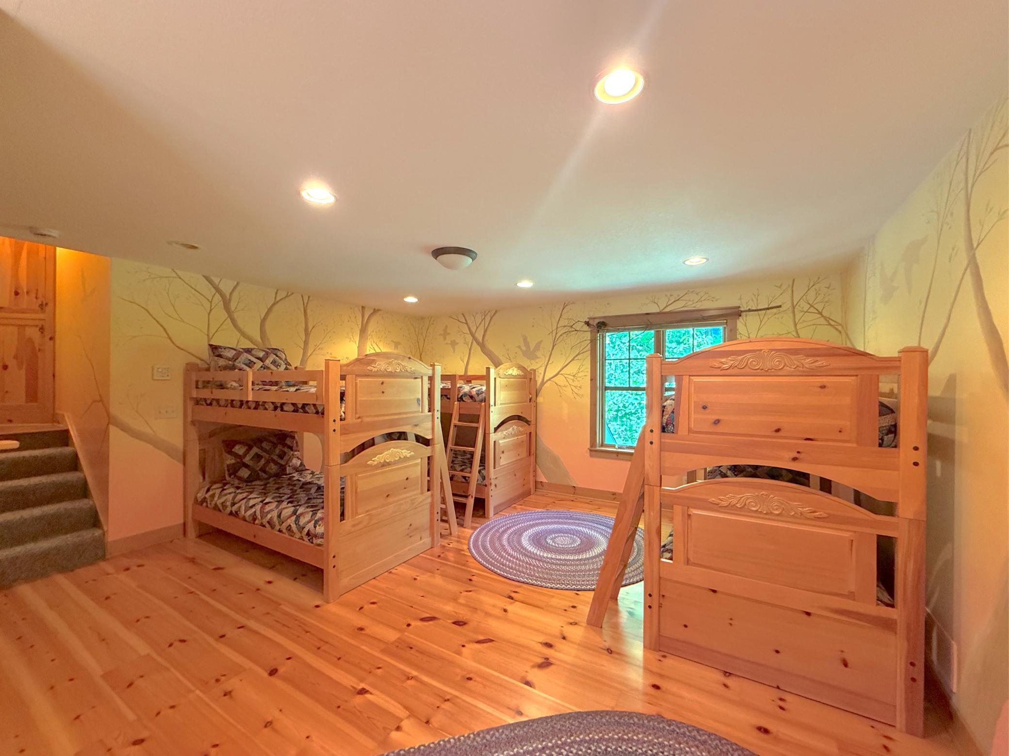 Another view of the space offering lake views and hardwood flooring, kids and parents alike will love this space!