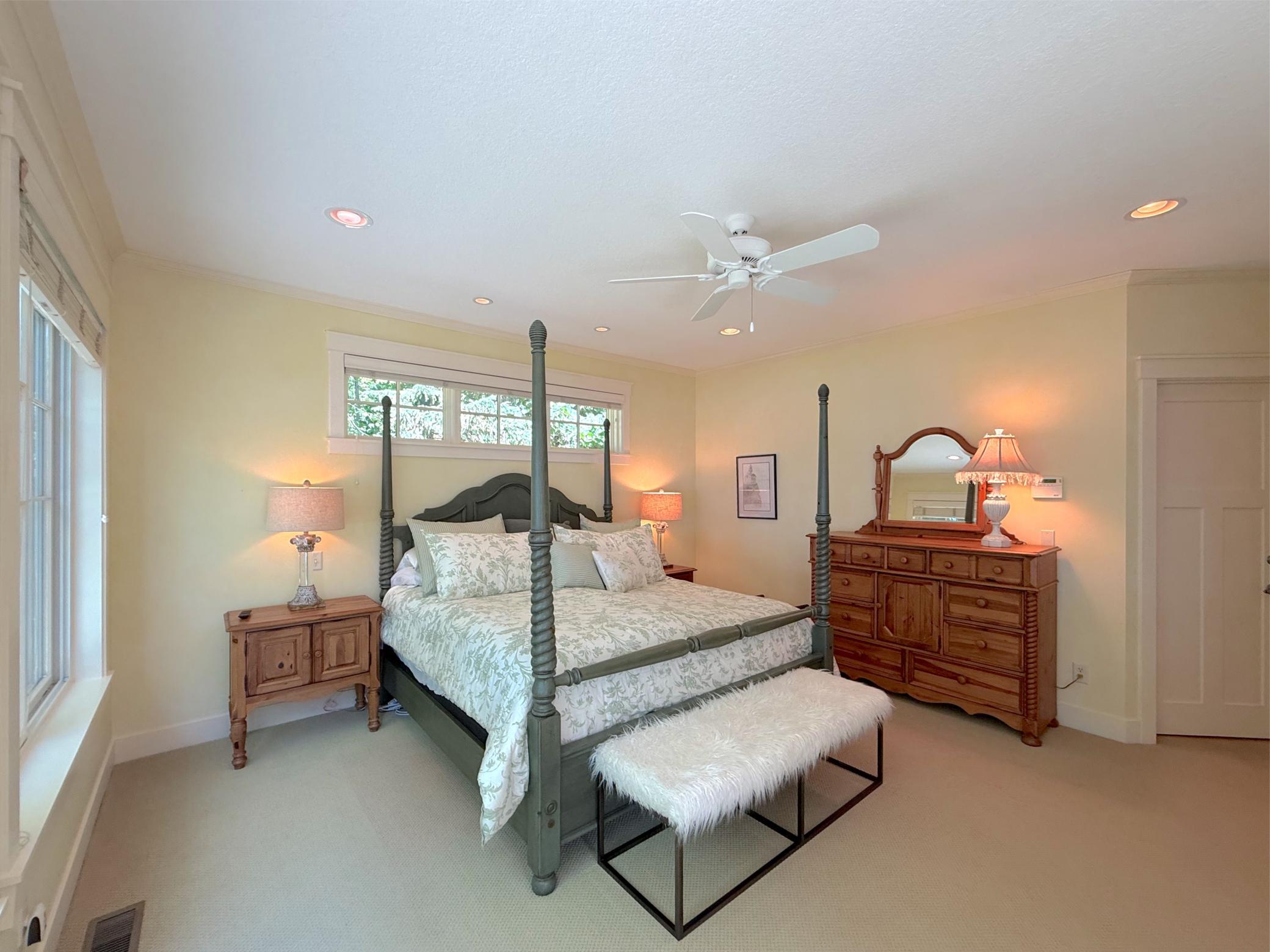 The primary suite is finished with a ceiling fan, can lighting, plush carpeting, luxury full bathroom and an expansive walk-in closet.
