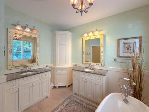 Relax in the gorgeous claw foot tub and enjoy plenty of storage space with double vanities including granite countertops.