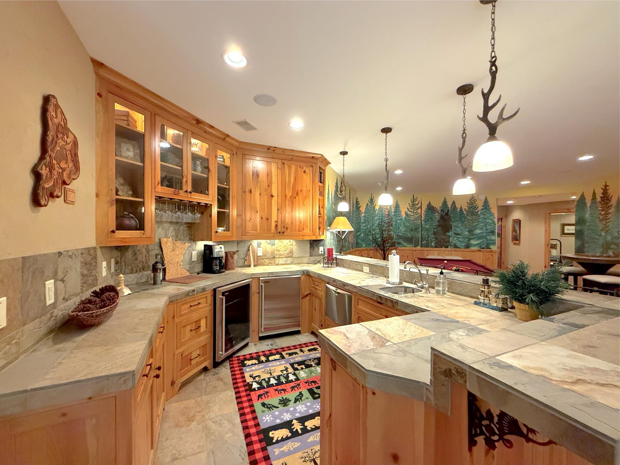 Complete with stainless steel wine & regular refrigerator, dishwasher, microwave and sink.