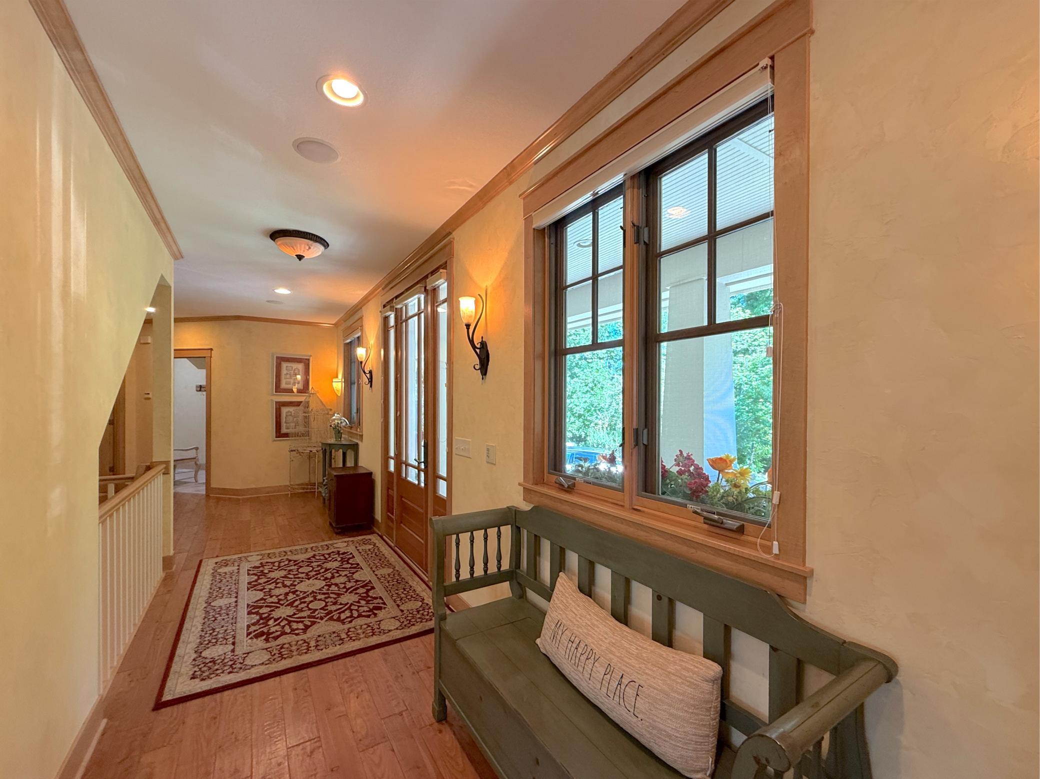 Enter into the home through a spacious foyer. Handscraped pine floors span across the main level living area.