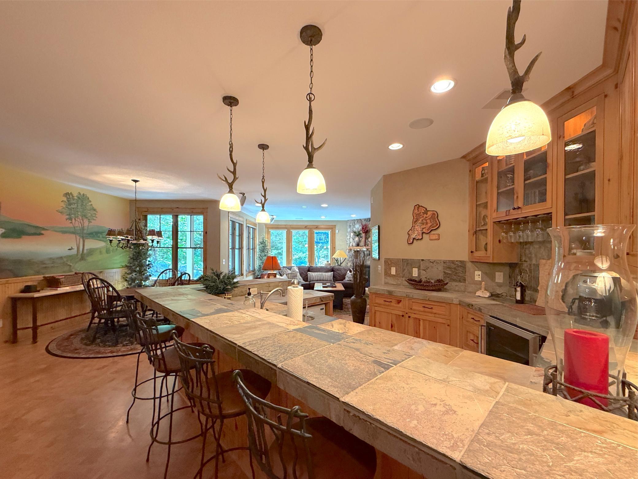 Functional cork flooring extends throughout the family room, recreational room and bar area.