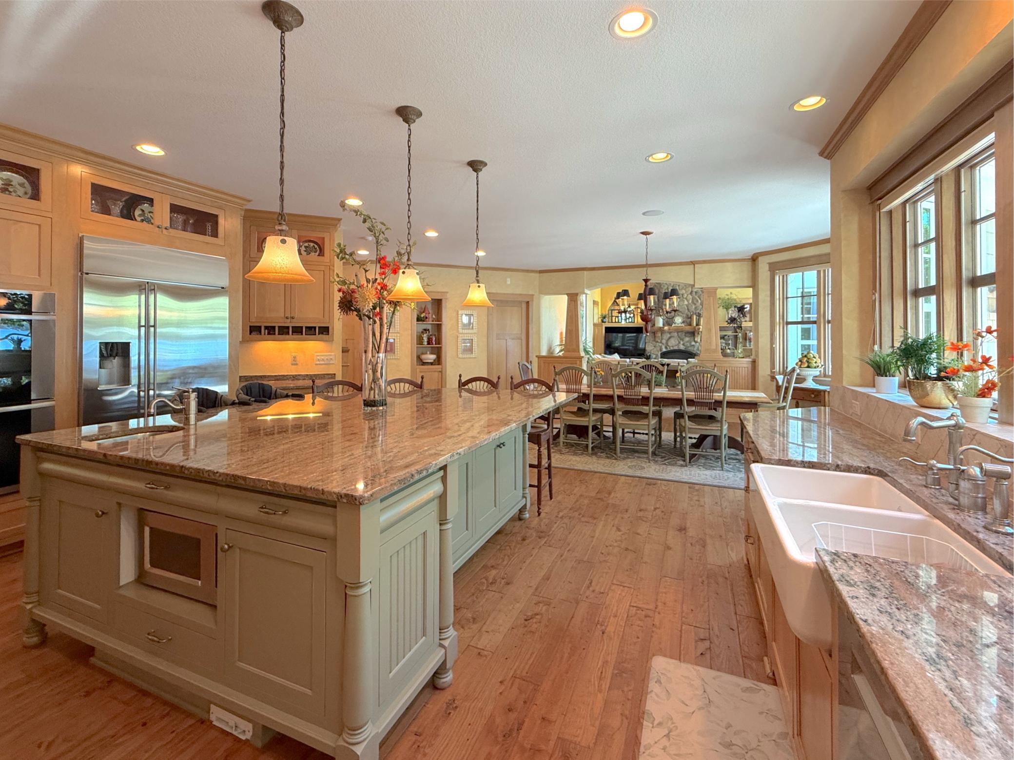 View of the spacious kitchen and dining room opening up to the living room through a gorgeous custom built archway.