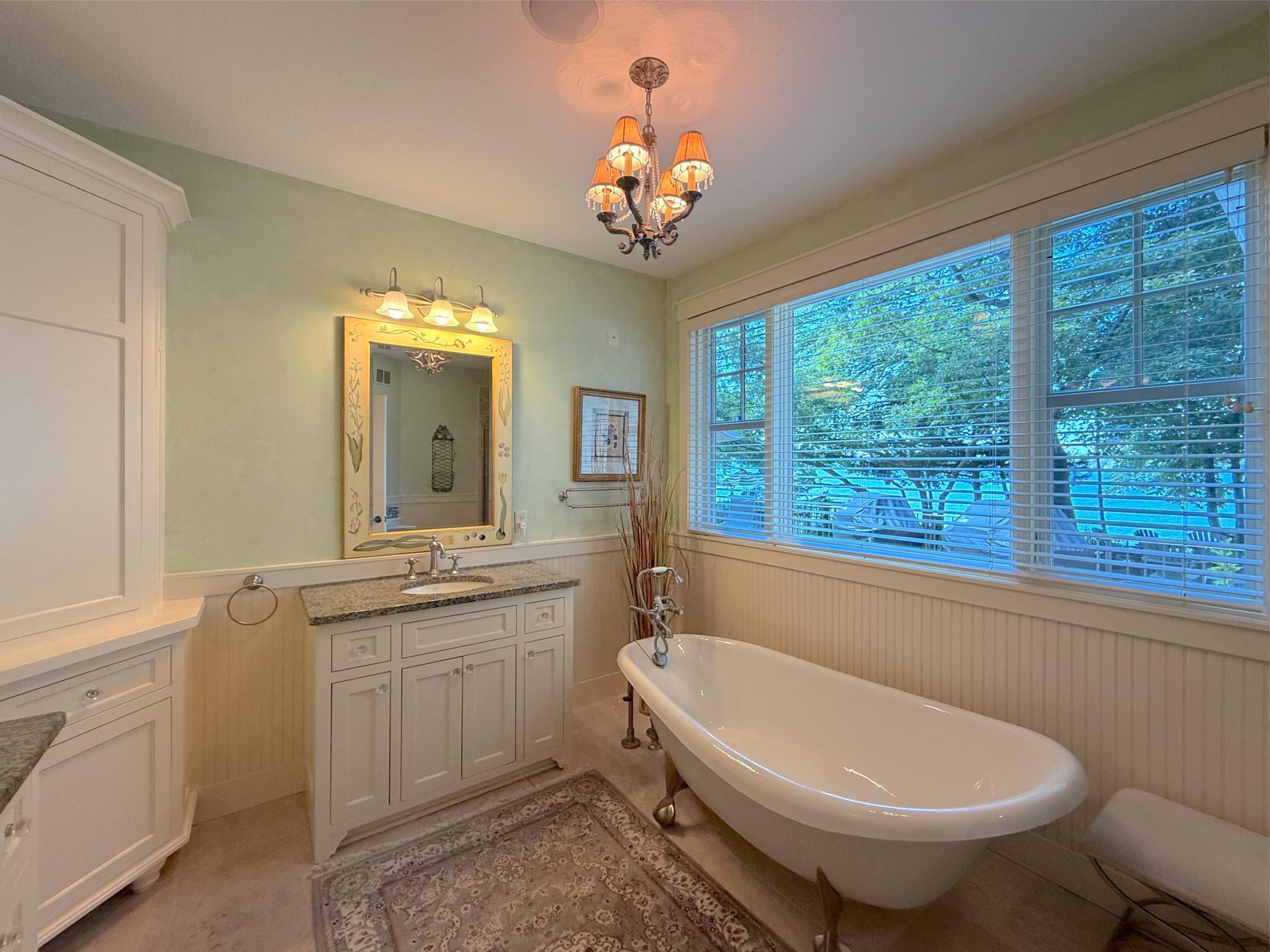 Stunning, the private primary full bathroom is dripping with natural light complete with tile flooring and a separate shower.