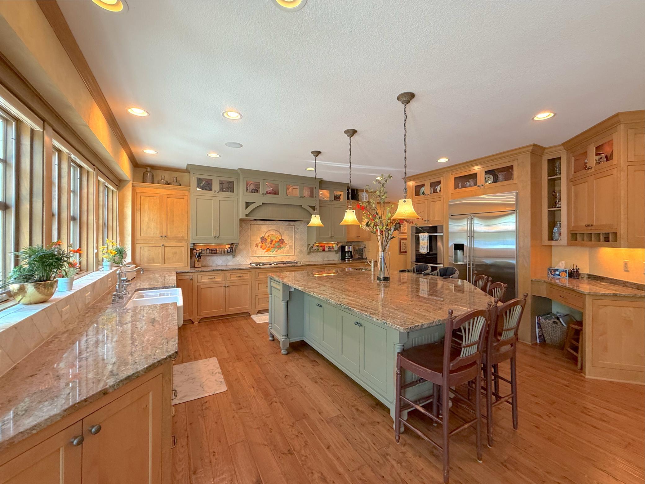The kitchen is certainly the heart of this home boasting fantastic granite countertops, center island and designer lighting.