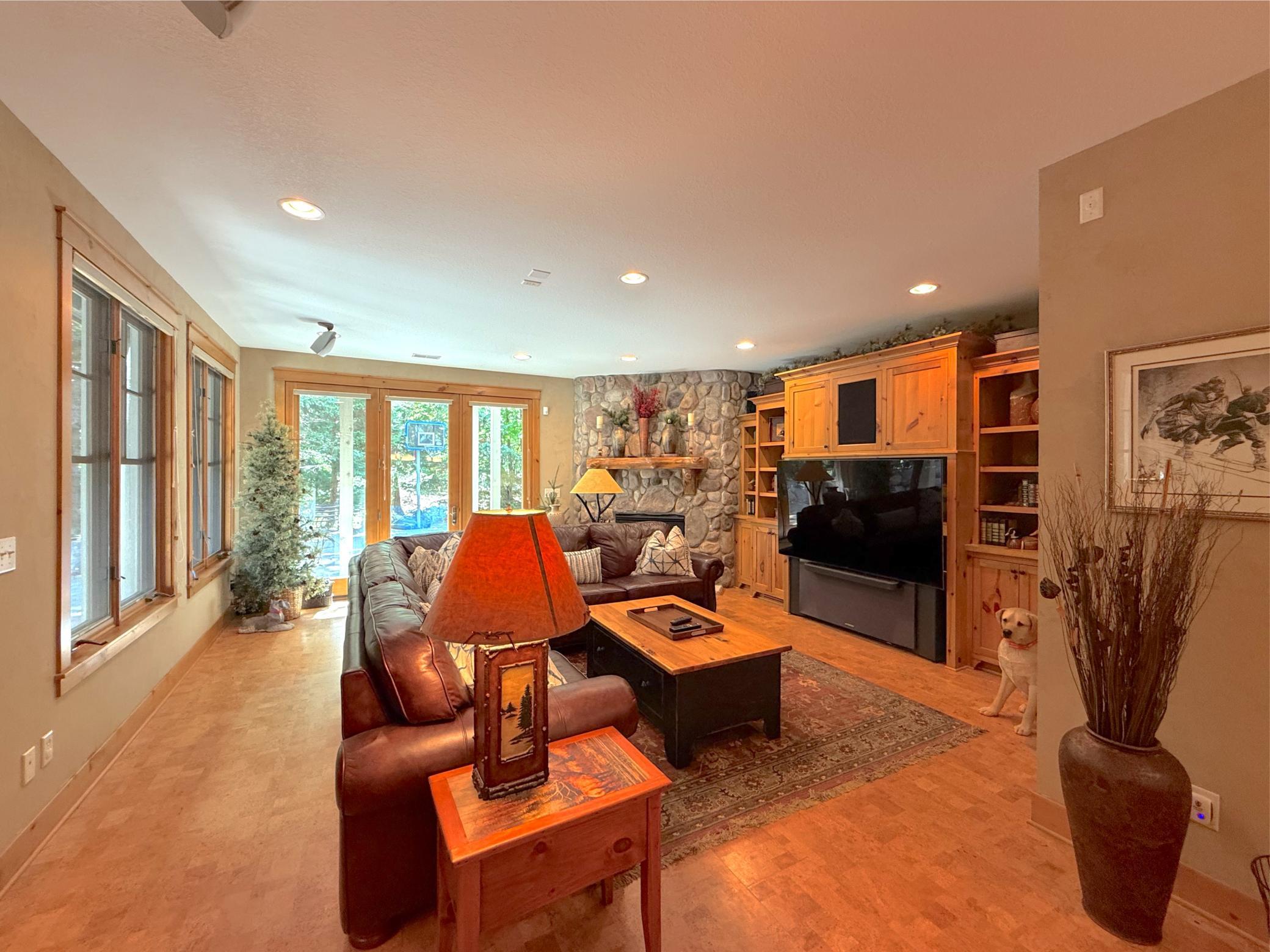 Unwind in the lower level family room with built-in custom entertainment center and cork flooring.