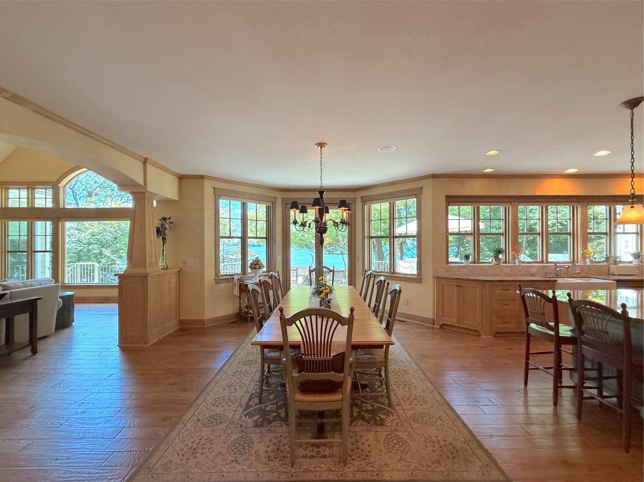 Gather around the spacious dining room that opens to the kitchen complete with a fantastic chandelier and wood floors.