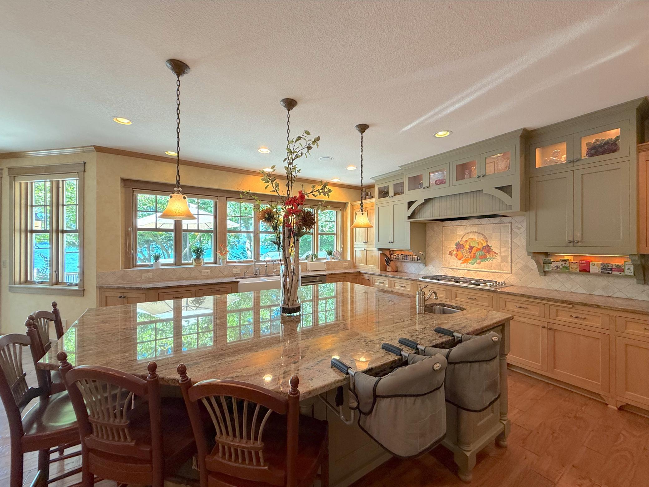 Enjoy stunning views of the lake right from the kitchen, walls of windows offer wonderful natural light throughout the space.