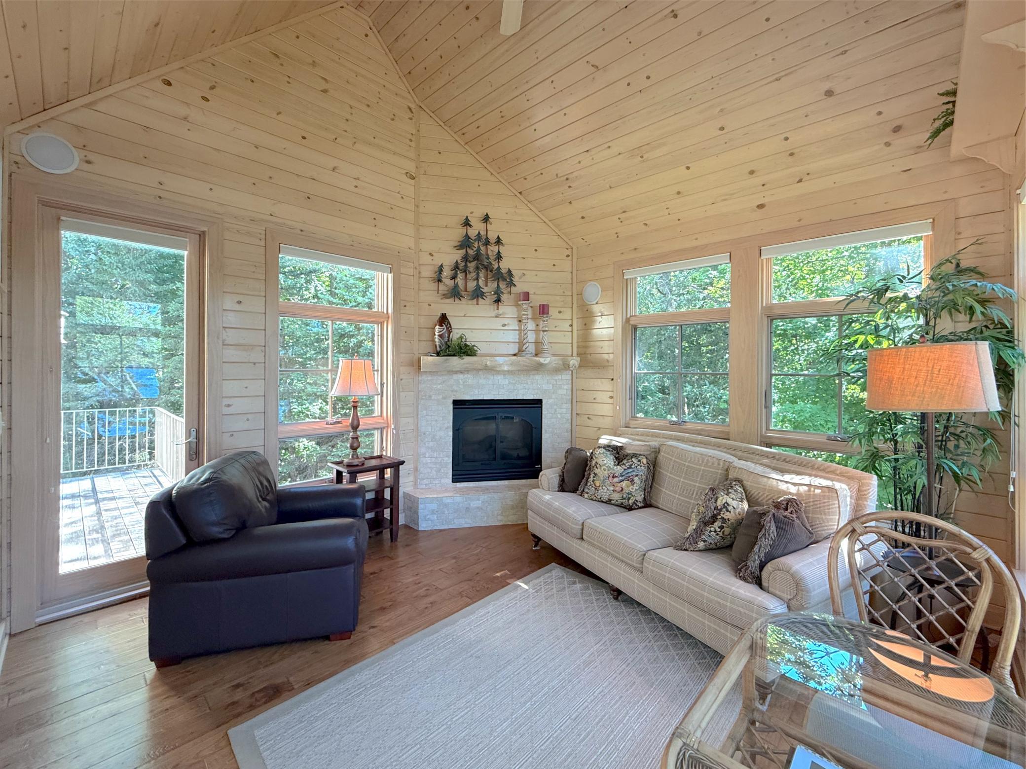 Surrounded with knotty-pine walls and door to the lakeside deck and side deck, grab a favorite book and relax.