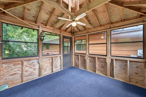 Inside of the 3-season porch overlook the backyard.