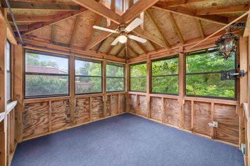 Inside of the 3-season porch overlook the backyard.