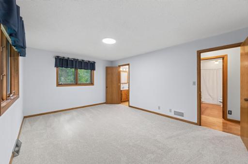 Primary bedroom on the main floor has a walk-in closet and private 1/2 bathroom.