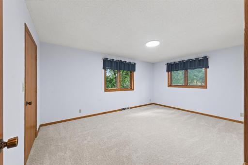 Primary bedroom on the main floor has a walk-in closet and private 1/2 bathroom.