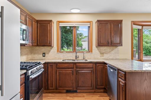Updated kitchen with granite countertops, bar seating and newer stainless steel appliances.