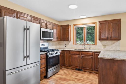 Updated kitchen with granite countertops, bar seating and newer stainless steel appliances.