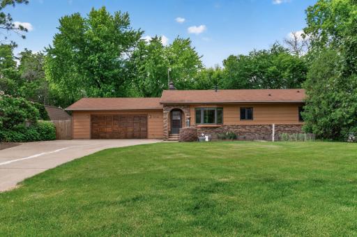 Large concrete driveway with extra parking pad beside the garage.