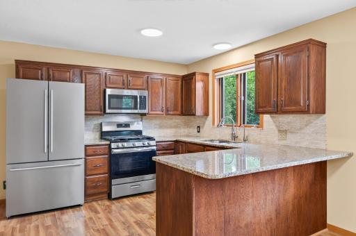 Updated kitchen with granite countertops, bar seating and newer stainless steel appliances.