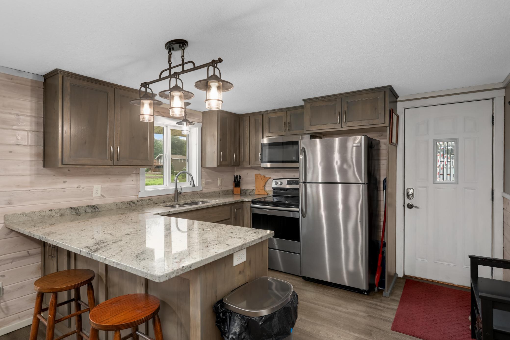 Nicely updated kitchen offering stainless steel appliances, granite countertops, and beautiful stained wood cabinets.