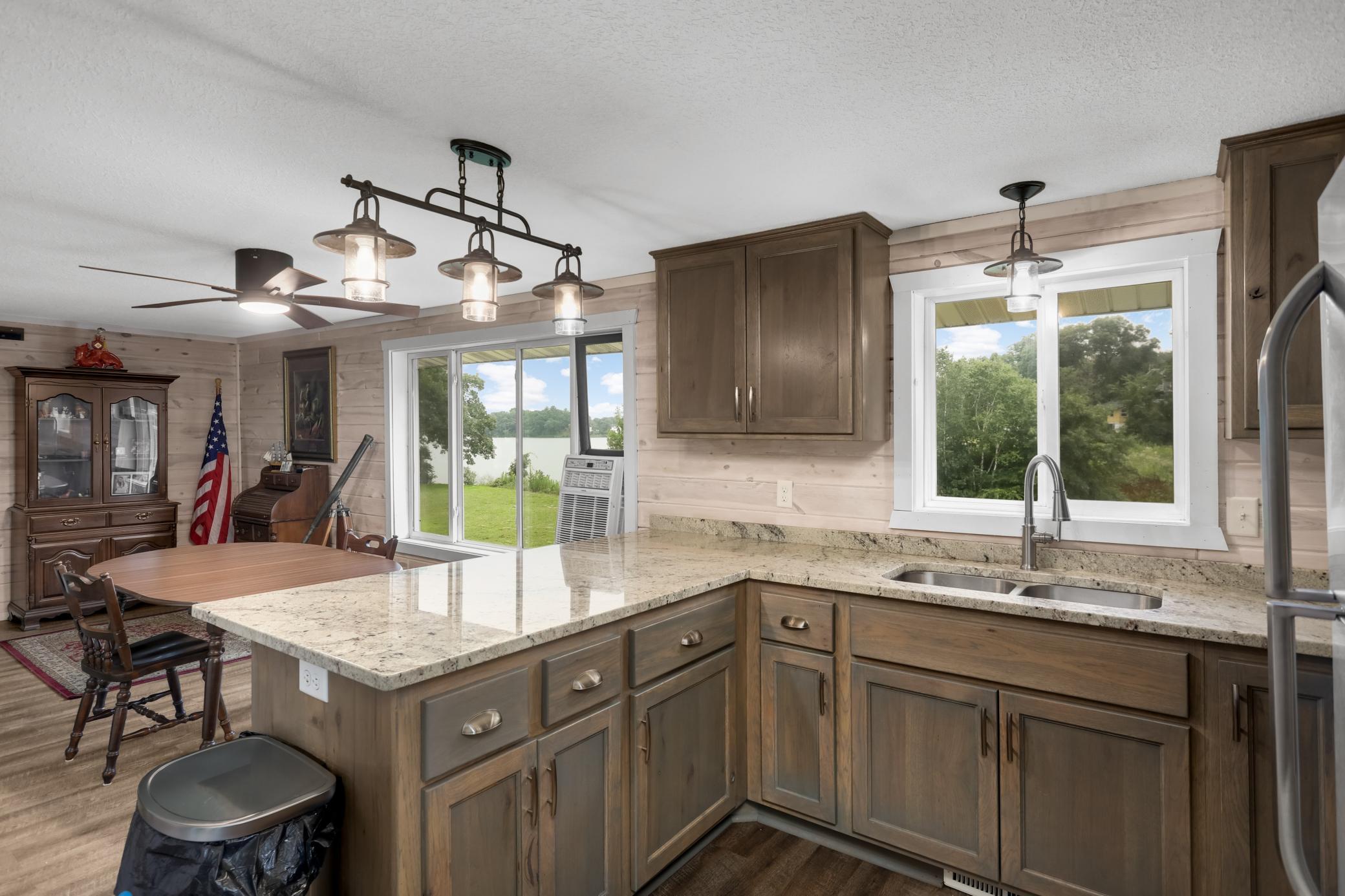 Desirable snack bar seating, accent wall in shiplap and large window over-looking lake and front yard.