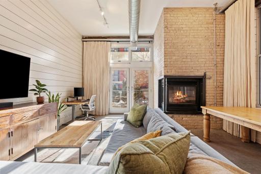 Statement corner gas fireplace with floor-to-ceiling brick