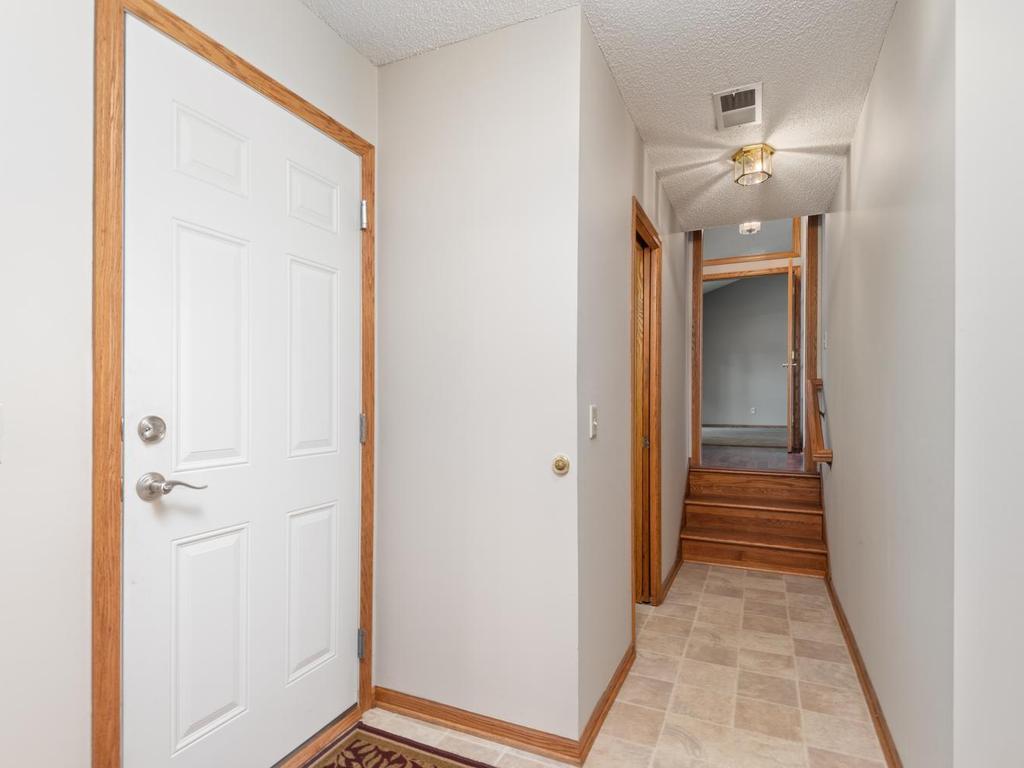 Garage service door and hallway leading back to the foyer.