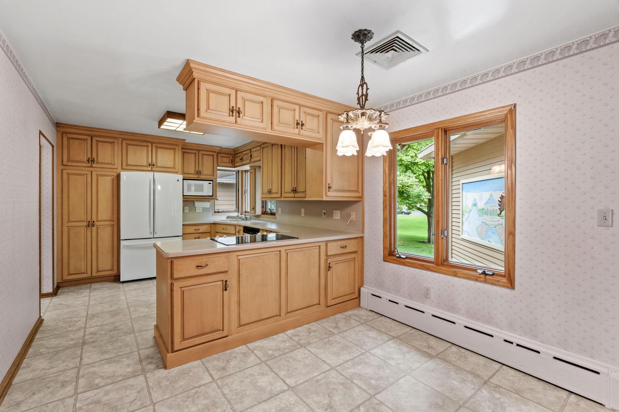 standing in the informal dining room looking onto kitchen