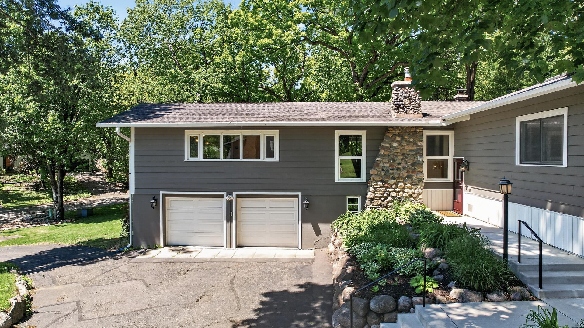 Aerial view of home's front showing two car tuck under garage