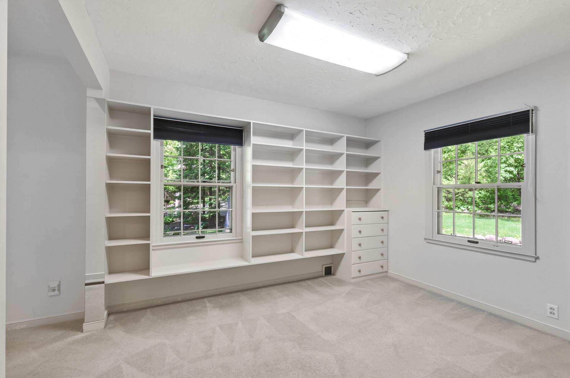 Main Floor third bedroom with built in Bookcases