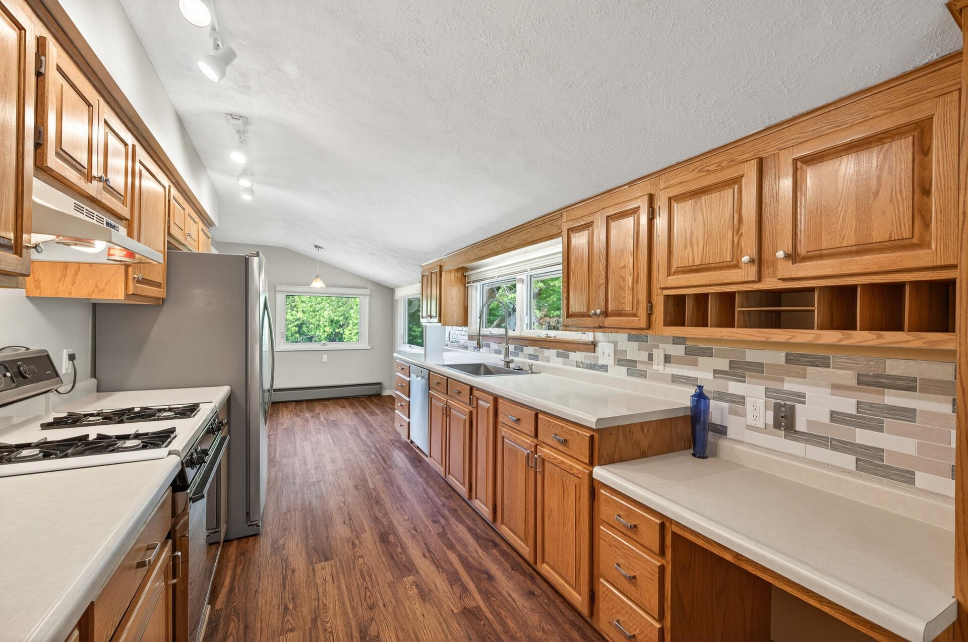 Kitchen with view to eat-in area. Note natural light is always encouraged throughout the entire home.