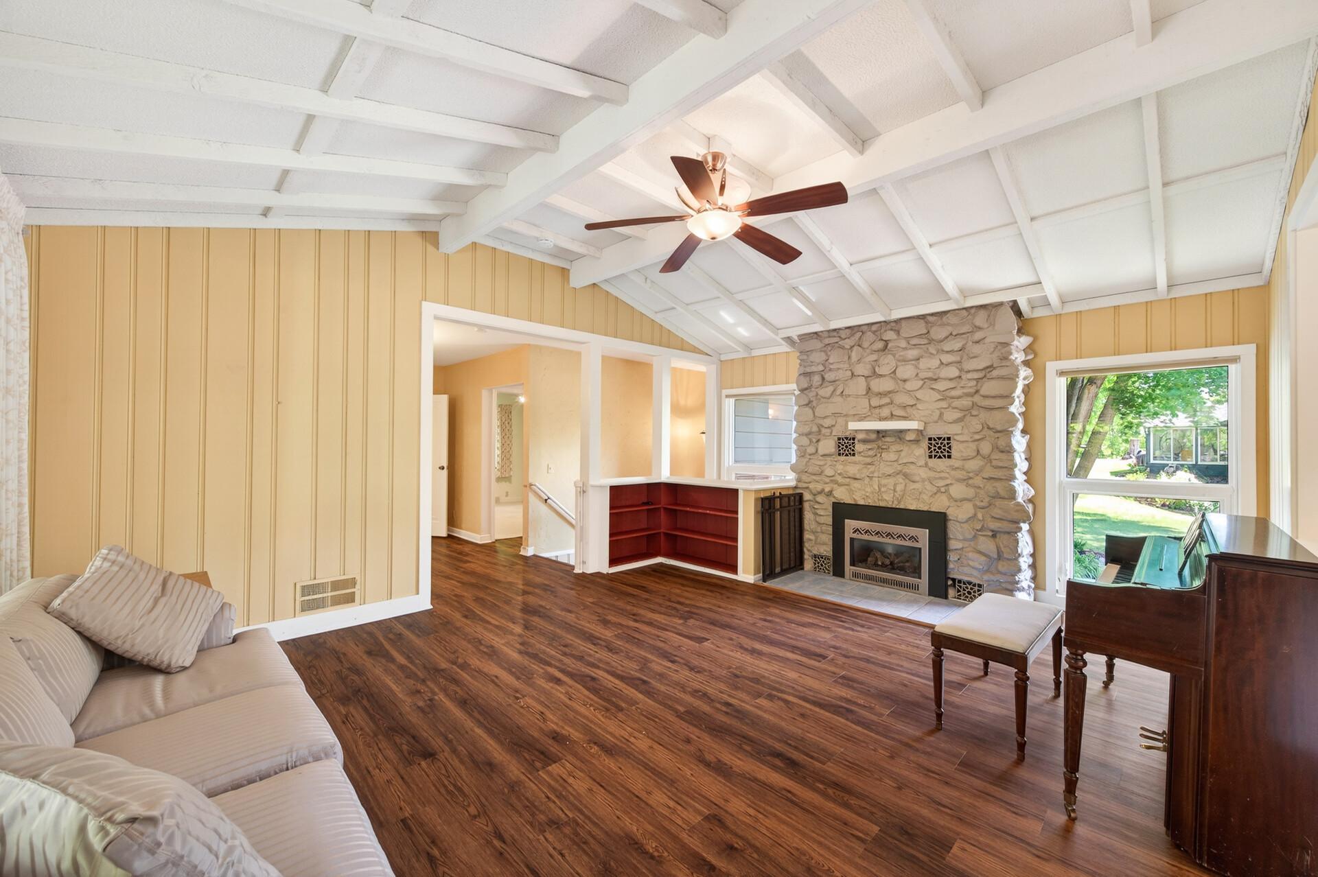Main Floor Family room with wood burning fireplace, currently housing an electric fireplace insert.