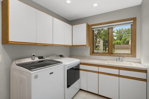 Convenient main-floor laundry in the mudroom off the garage. Sink, cabinets, and closet (not pictured)