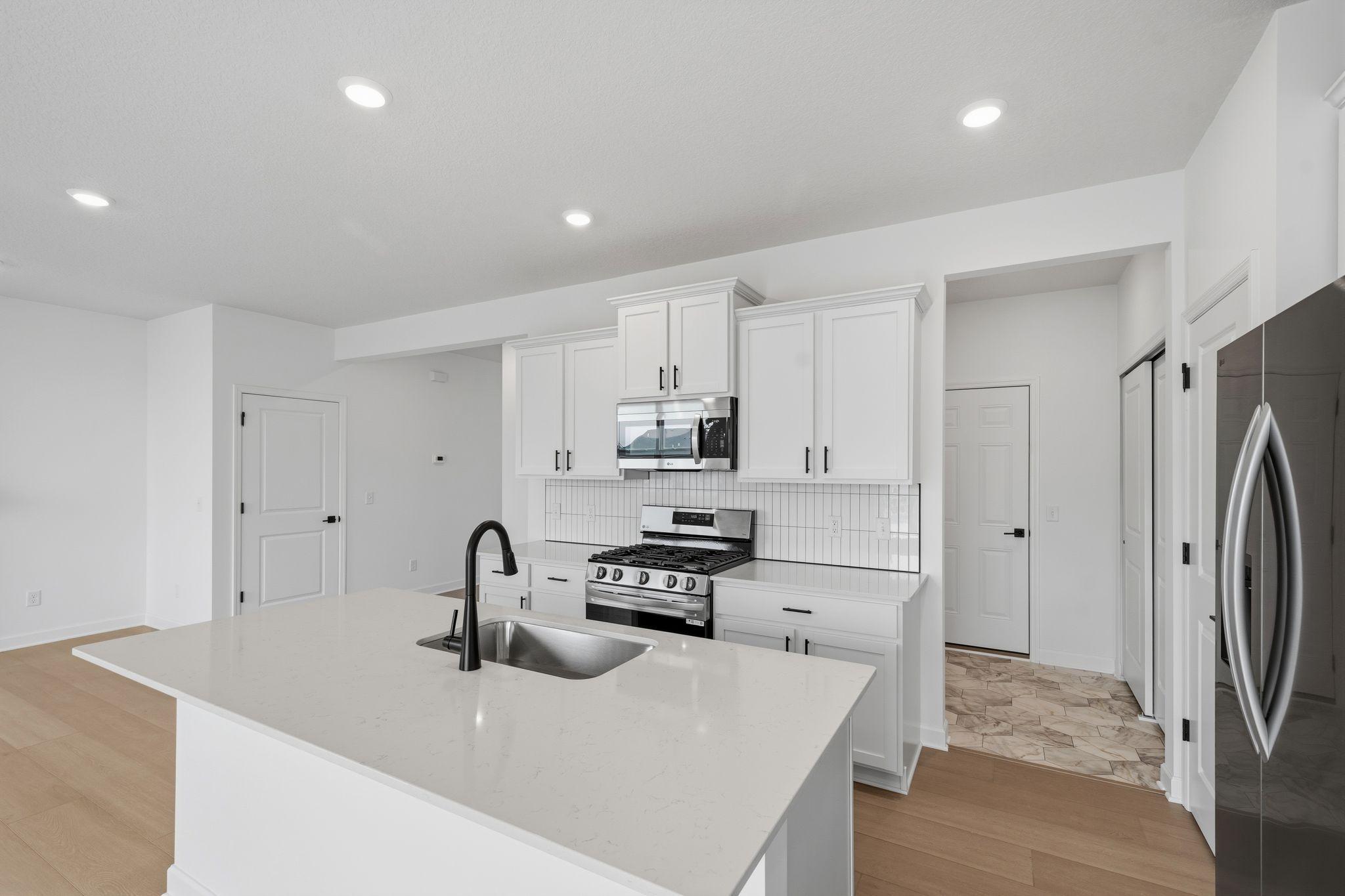 (Photo of a similar home, actual finishes may vary) All kitchens come with high-end finishes and designer appliances